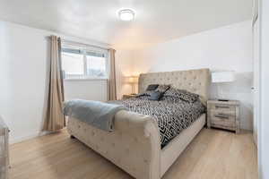 Bedroom with light hardwood / wood-style floors