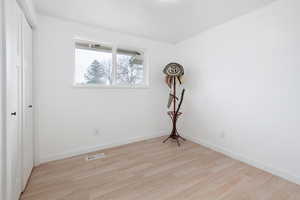 Empty room with light hardwood / wood-style flooring