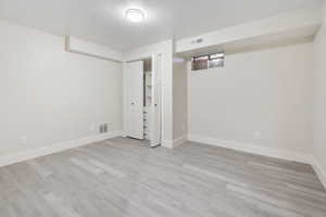 Interior space featuring a textured ceiling and light wood-type flooring