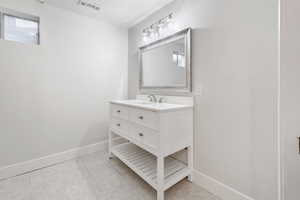 Bathroom featuring tile patterned floors and vanity