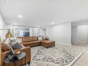 Living room with carpet floors and built in shelves