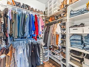 Spacious closet with hardwood / wood-style flooring
