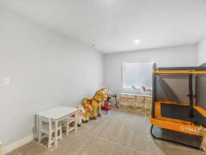 Game room with carpet flooring