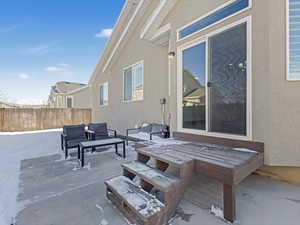 Snow covered patio with outdoor lounge area