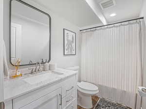 Bathroom with hardwood / wood-style flooring, vanity, and toilet