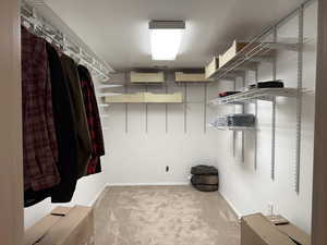 Walk in closet with carpet flooring