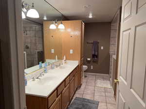 Bathroom featuring tile patterned flooring, vanity, and toilet