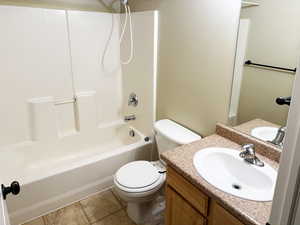 Full bathroom featuring shower / bath combination, vanity, and toilet