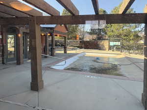 View of pool with a patio area and a pergola