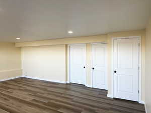 Unfurnished bedroom featuring recessed lighting, a closet, baseboards, and dark wood-type flooring