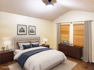 Carpeted bedroom featuring lofted ceiling