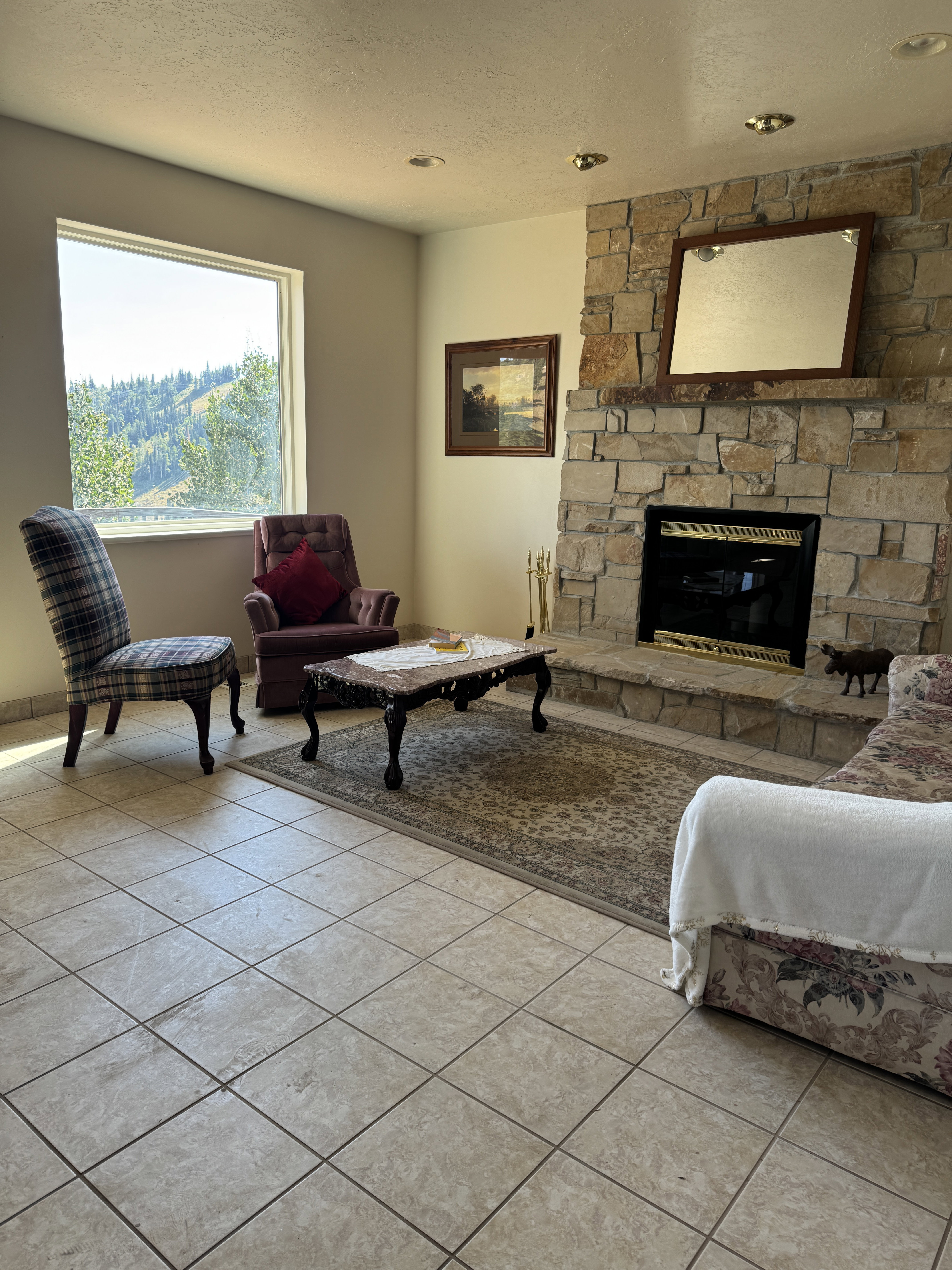 Living room with real wood fireplace and rock hearth.