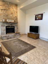 Rock hearth on a real wood fireplace in the basement living room area.