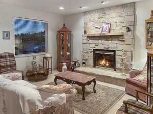Tiled living room with a fireplace and view of the slopes