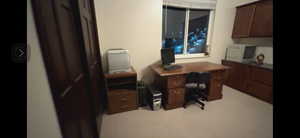 View of  ski slopes from the home office  with built in cabinets  could be fifth bedroom has closet