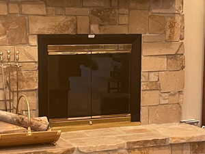 Interior details featuring a stone fireplace for real wood