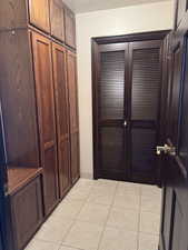 Hallway with light tile patterned floors