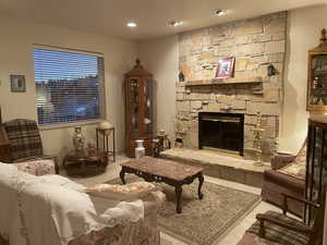 Interior space with light tile patterned flooring and a fireplace