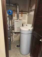 Utility room featuring a heating unit