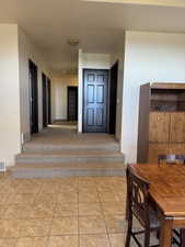 Interior space featuring stairway and light tile patterned floors