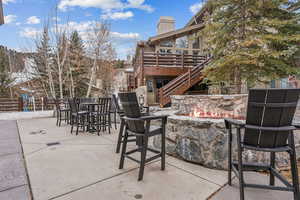 View of patio with a mountain view and a fire pit