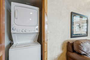 Washroom with stacked washer and clothes dryer