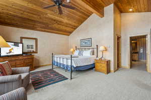 Carpeted bedroom featuring beam ceiling, wood ceiling, and high vaulted ceiling