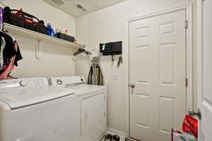 Washroom featuring washer and clothes dryer