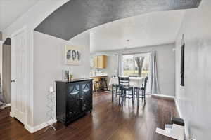 Dining room featuring a textured ceiling and dark hardwood / wood-style flooring