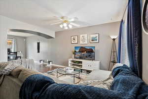 Living room featuring ceiling fan and wood-type flooring