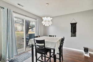 Dining area featuring hardwood / wood-style floors and a notable chandelier