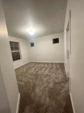 Empty room with dark colored carpet