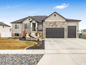 Craftsman-style house with a garage and a front yard