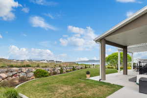 View of yard with a patio and a water and mountain view