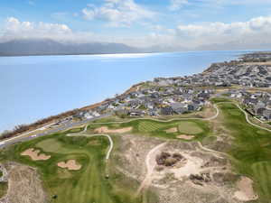 Aerial view of backyard with a residential view, golf course view, and a water and mountain view