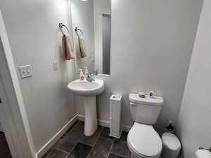 Bathroom with sink, toilet, and tile patterned flooring