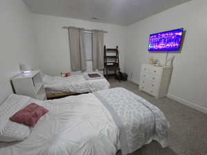 Bedroom featuring light colored carpet