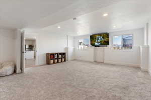 Unfurnished living room with a textured ceiling and carpet