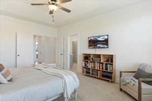 Carpeted bedroom with ceiling fan