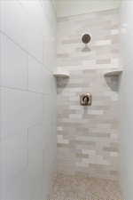 Bathroom featuring a tile shower