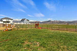 View of yard featuring a rural view and a mountain view