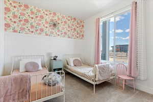 Bedroom with multiple windows and carpet