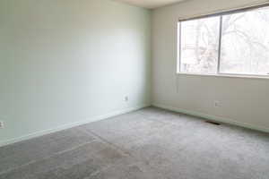 Empty room featuring carpet flooring