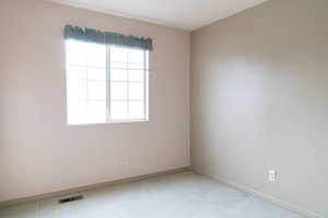 Unfurnished room with light carpet
