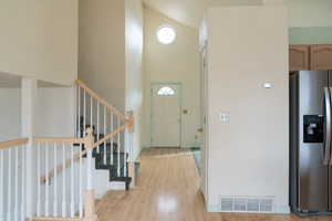 Foyer featuring light hardwood / wood-style flooring and a high ceiling