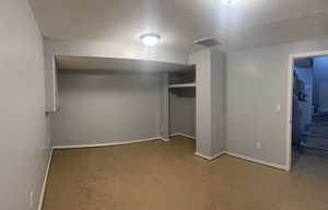 Unfurnished bedroom featuring a closet and a textured ceiling