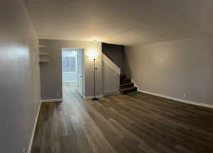 Interior space with dark hardwood / wood-style floors and a textured ceiling