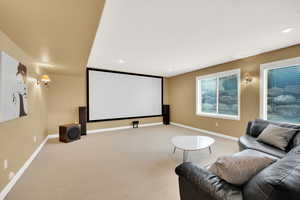 Basement living room with a projector, screen and sound system