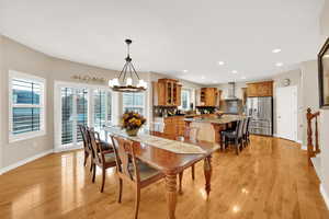 Dining room featuring a chandelier, hardwood floor, entrance to backyard