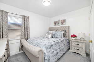 Bedroom with light colored carpet